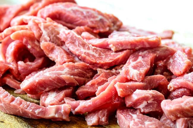 showing how to make Mongolian beef by slicing flank steak thinly across the grain