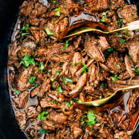 This is the BEST Slow Cooker Barbacoa Beef I have ever tried!ย Super tender, juicy, EASY and bursting with rich, complex flavors!ย Great for large crowds or make ahead meals and makes the best tacos, burritos, nachos, salads, etc!
