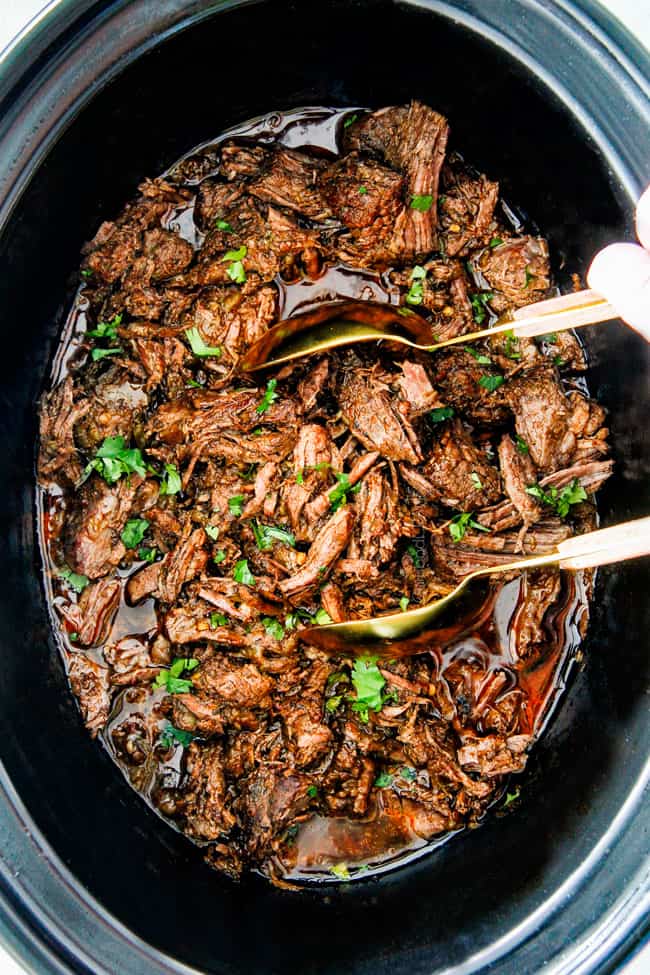 This is the BEST Slow Cooker Barbacoa Beef I have ever tried!ย Super tender, juicy, EASY and bursting with rich, complex flavors!ย Great for large crowds or make ahead meals and makes the best tacos, burritos, nachos, salads, etc!