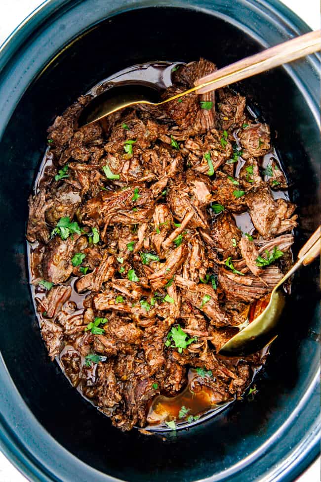 Shredded Chipotle Beef Barbacoa serving with tongs.