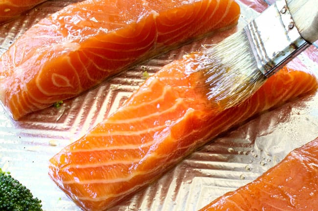 showing how to make Honey Soy Salmon by brushing salmon with olive oil