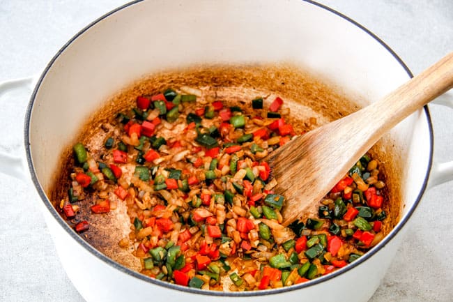 Easy 30-Minute Homemade Chicken Tortilla Soup that tastes better than any restaurant!ย ย It's accidentally healthy, easy to double/triple for a crowd, freezer friendly and tastes like it's been simmering for hours but on your table in 30 Minutes!ย ย Showing How to Make Chicken Tortilla Soup by sauteinig onions, garlic, red bell peppers, poblano peppers and onions
