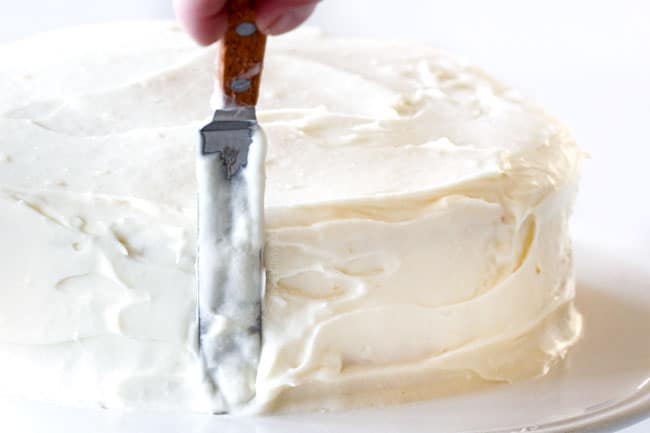 How to make easy Coconut Cake by frosting top and all sides with Coconut frosting