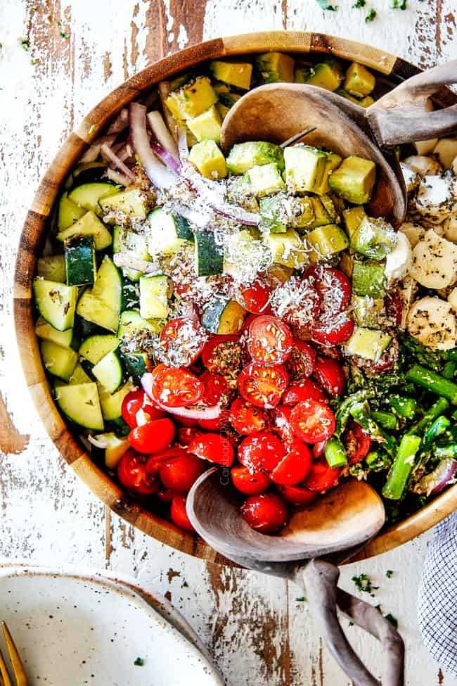 top view of Tomato Cucumber Onion Salad recipe with cherry tomatoes, cucumbers, onion, asparagus and avocado