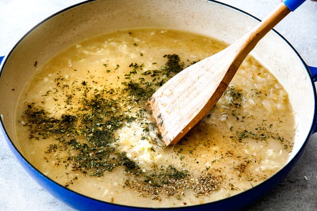 Showing how to prepare Lemon Rice by adding chicken broth, water and lemon juice to a pot with fresh dill and parsley