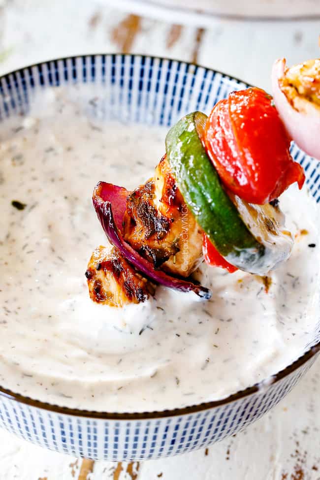 dipping chicken souvlaki with tzatziki
