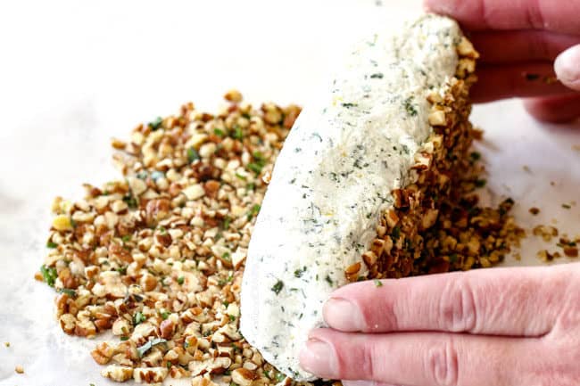 rolling cheese log in pecan mixture