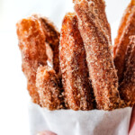 easy churros in a white bag standing straight up