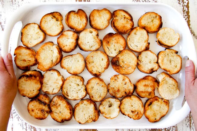 toasting baguette slices for strawberry goat cheese bruschetta