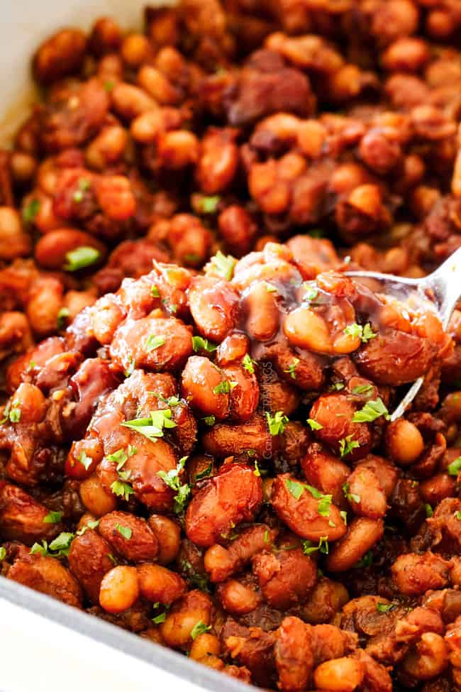Scooping Homemade Baked Beans with a silver spoon