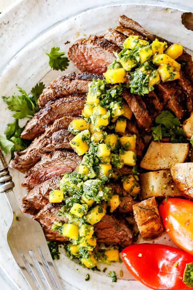 top view of Brazilian Chimichurri steak sliced on a plate with chimichurri