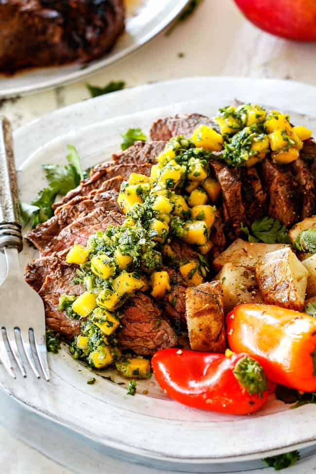 Brazilian Chimichurri steak sliced on a plate with chimichurri