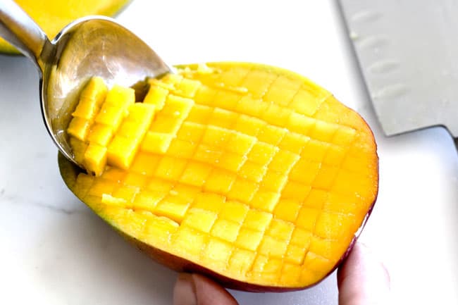 showing how to dice mango for mango chimichurri Steak