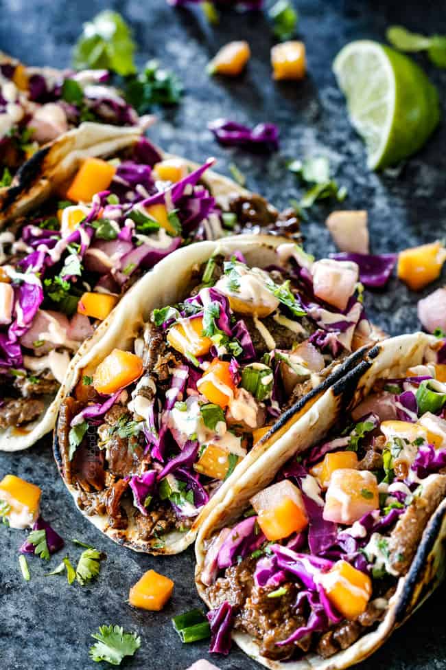 far away shot of Korean tacos with steak in a flour tortilla with Pear Mango Slaw