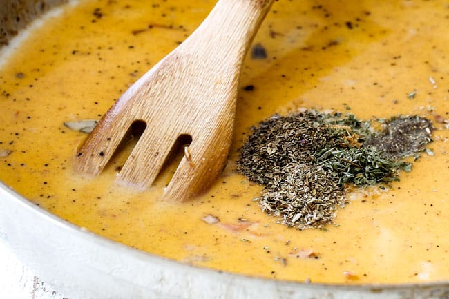 showing how to make Sun-Dried Tomato Pasta by stirring seasonings into sauce