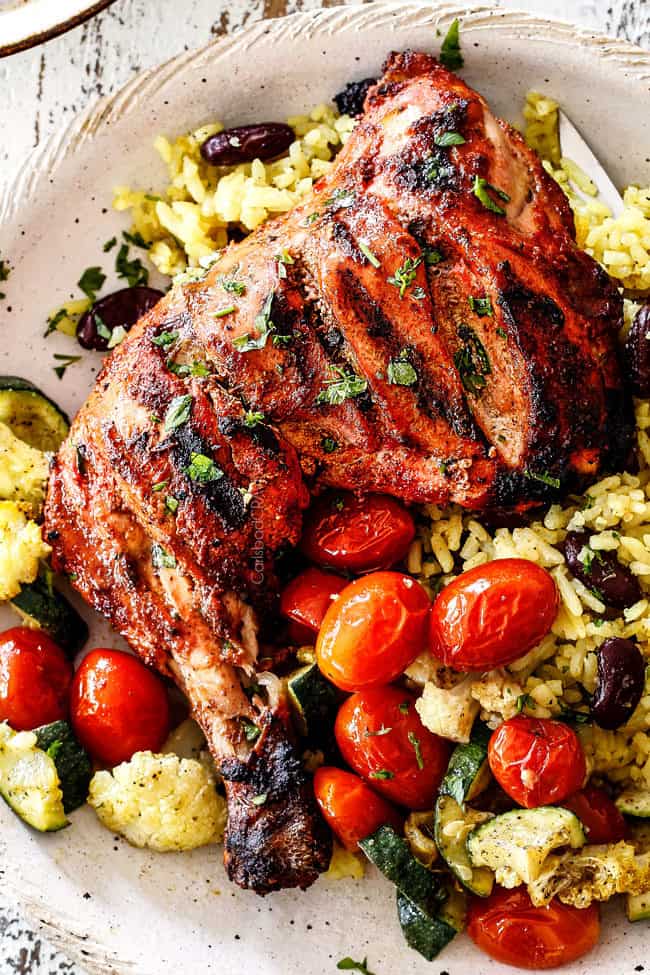 top view of authentic tandoori Chicken with Indian rice and roasted tomatoes