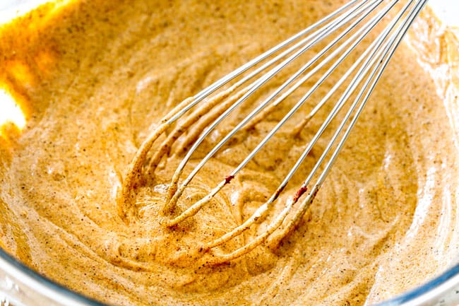 showing how to Tandoori Chicken at home by whisking together marinade ingredients