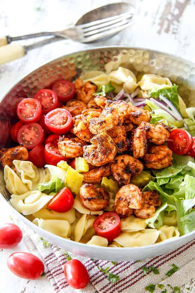 side view of Shrimp Pasta salad with tortellini, lettuce, tomatoes and shrimp