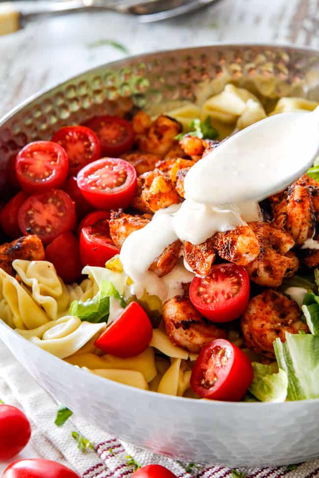 Dressing with mayo for Shrimp Pasts Salad being drizzled over shrimp