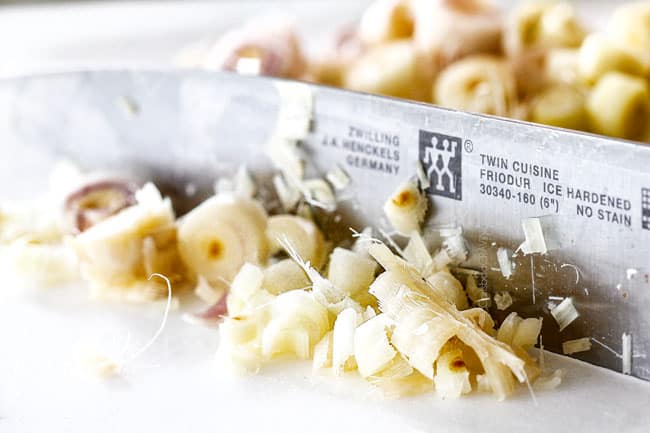 showing how to make lemongrass chicken by chopping lemongrass