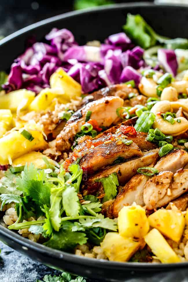 show how to serve lemongrass chicken in rice bowl with pineapple, cabbage and carrots