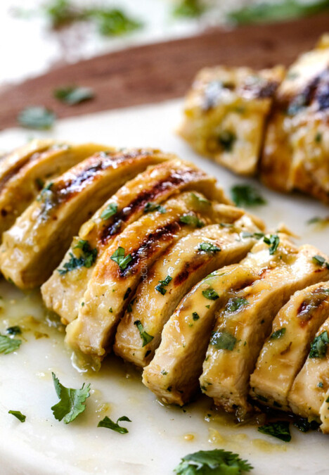 up close of sliced salsa verde chicken on a cutting board