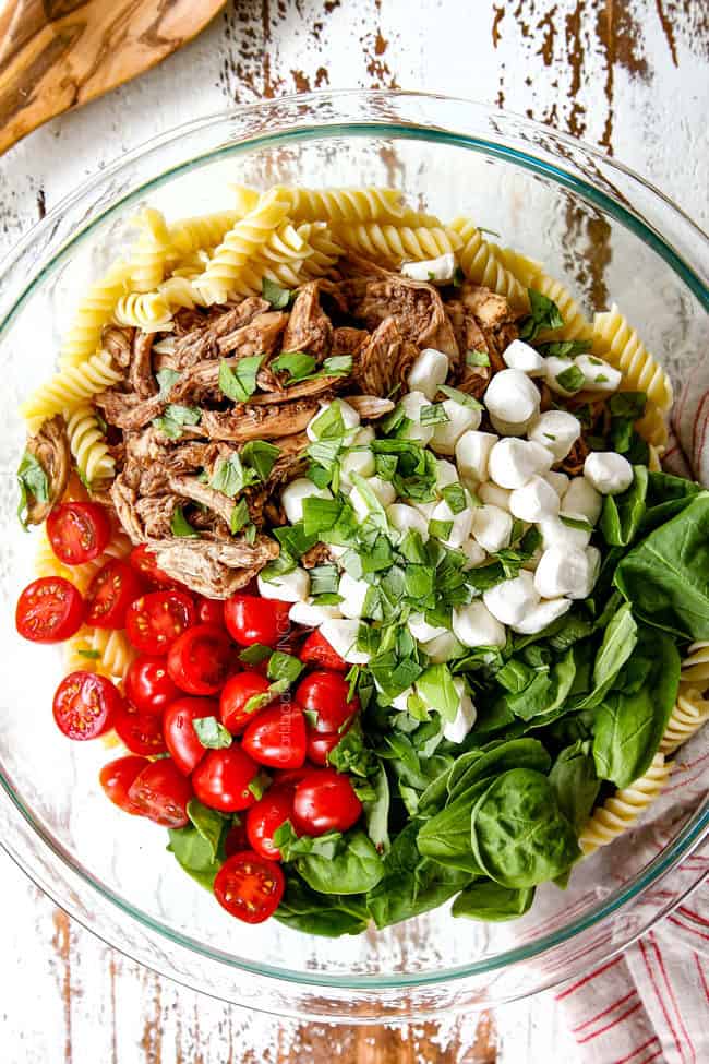 top view showing how to make caprese pasta salad with balsamic chicken, spinach tomatoes mozzarella