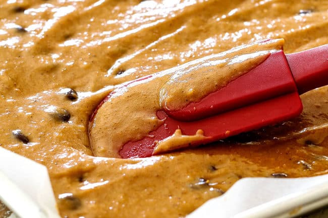 showing how to make easy pumpkin bars by spreading batter into the pan