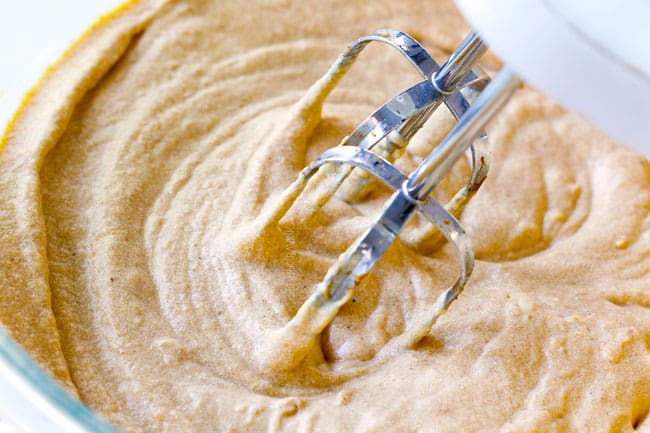 showing how to make pumpkin dip by beating heavy cream into pumpkin dip until fluffy