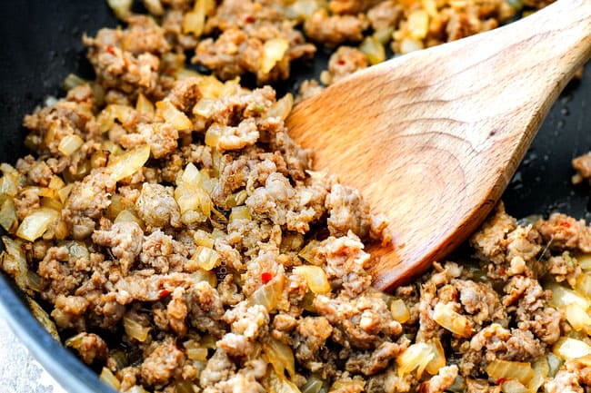 showing how to make easy sausage stuffed mushrooms by cooking Italian sausage and onions in a skillet