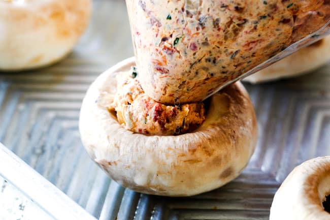 showing how to make sausage stuffed mushrooms by filling mushrooms with sausage cream cheese filling