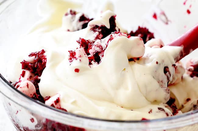 showing how to make ambrosia salad by stirring creamy dressing into salad