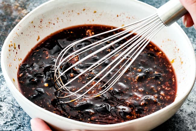 showing how to make hoisin chicken by by whisking together hoisin marinade ingredients