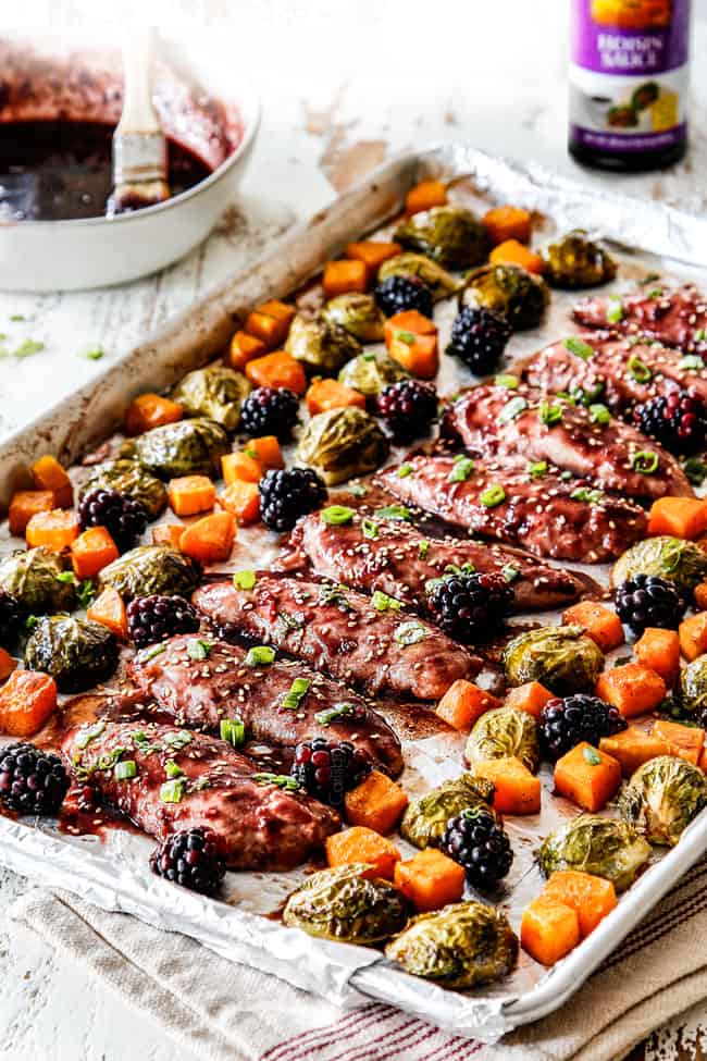 side view of hoisin chicken on a sheet pan with butternut squash and brussels sprouts