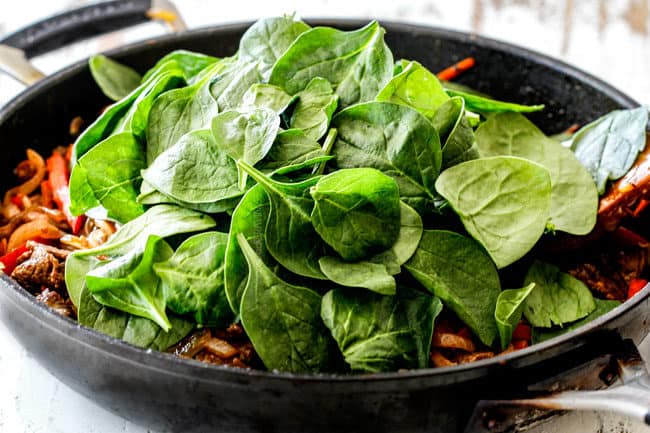 showing how to make Korean Noodles by adding spinach to skille