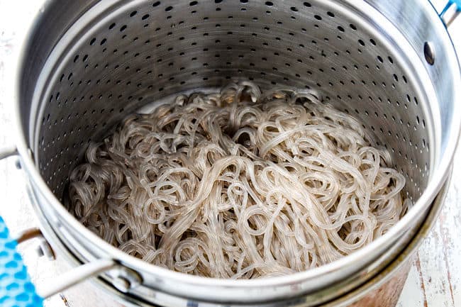showing how to make korean spicy noodles by cooking dangmyeon in a pot