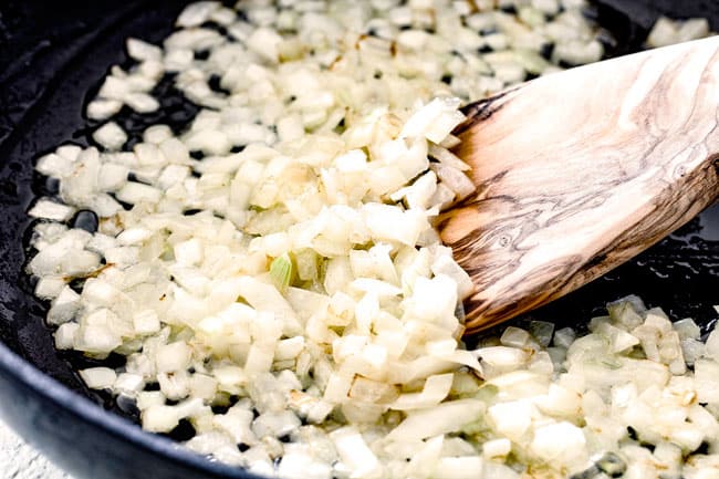 showing how to make vegetarian wild rice recipe by cooking onions and garlic in a skillet