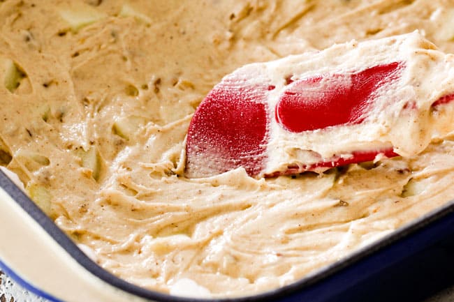 showing how to make poke cake by spreading batter into pan