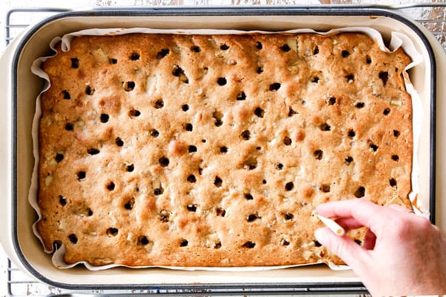 showing how to make poke cake by poking holes into cake