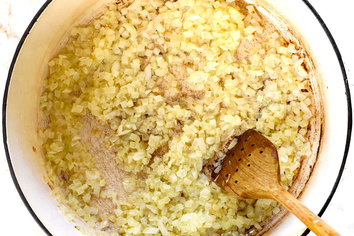 showing how to make broccoli cheese soup by sautรฉing onions in a large soup pot