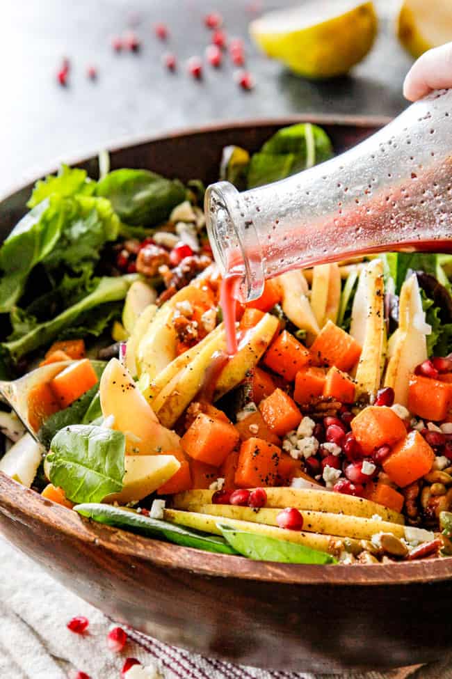 pouring fall salad dressing over salad