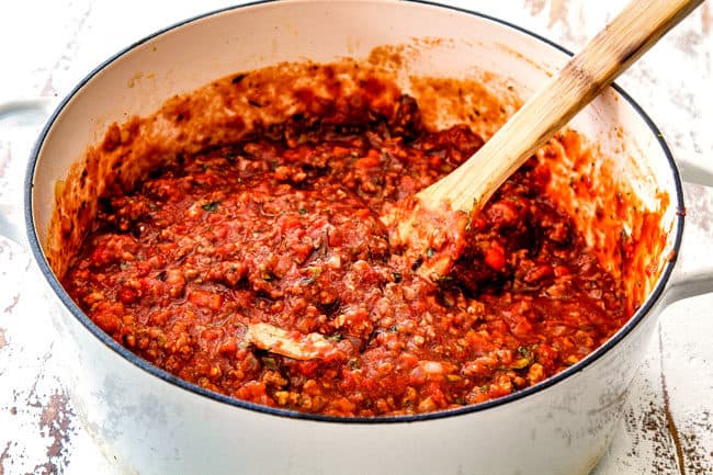 showing how to make easy lasagna by simmering homemade meat sauce in a white Dutch oven