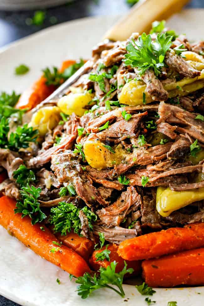 up close of Mississippi Pot Roast with carrots on a white platter