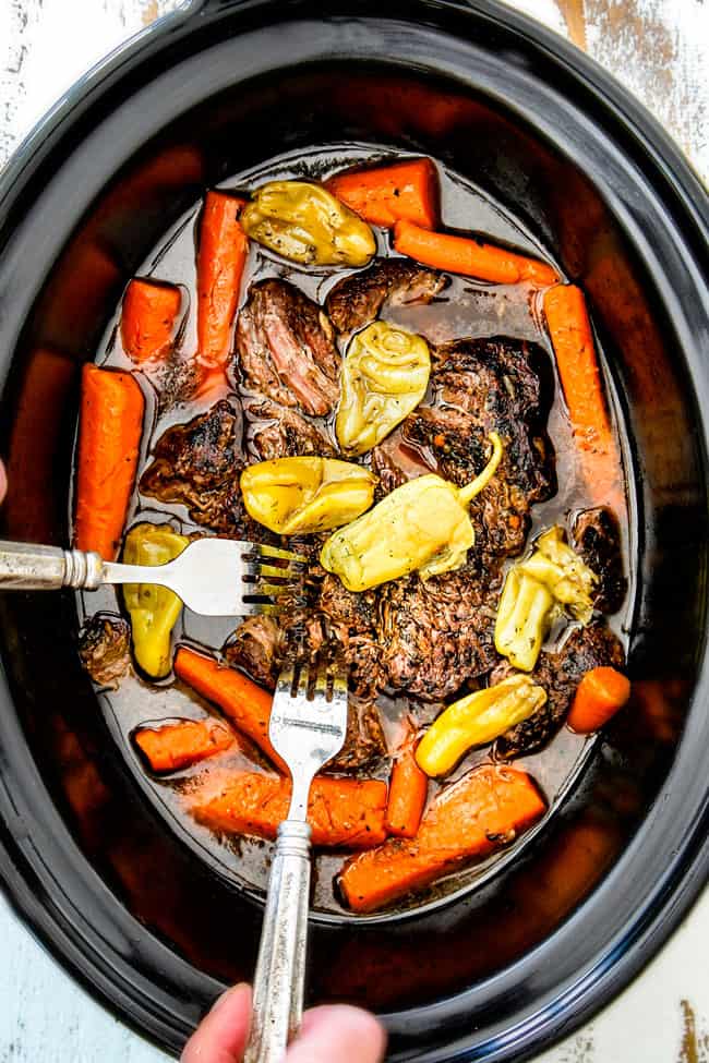 showing how to make Mississippi Pot Roast in crock pot by shredding chuck roast