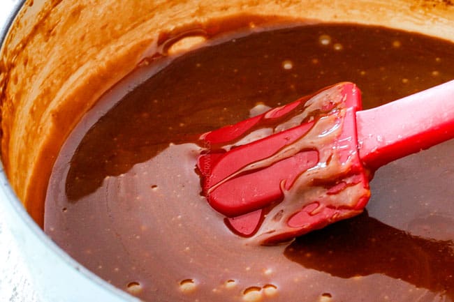 showing how to make pecan topping for Pecan Pie Cheesecake by melting butter and sugar together in a saucepan