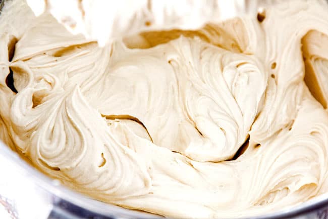 showing how to make easy pecan pie cheesecake by whipping cream cheese, brown sugar, sour cream, vanilla, and eggs until smooth