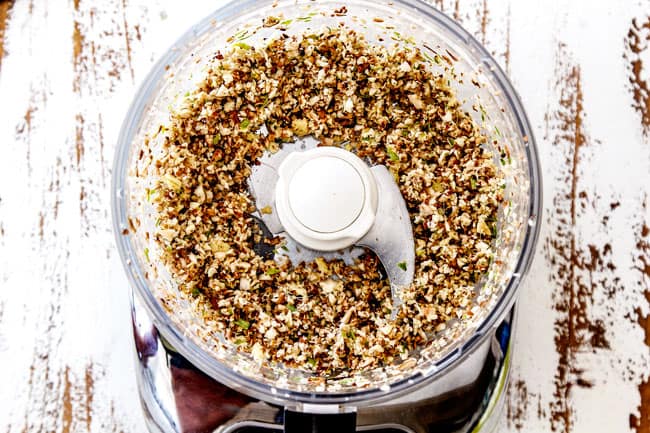 showing how to make wonton filling for Wonton Soup by chopping ginger, garlic, mushrooms and green onions in a food processor