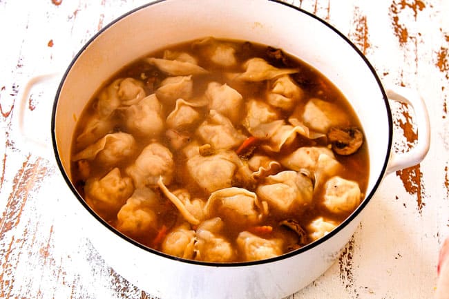 showing how to make easy wonton soup recipe by cooking wontons in the broth