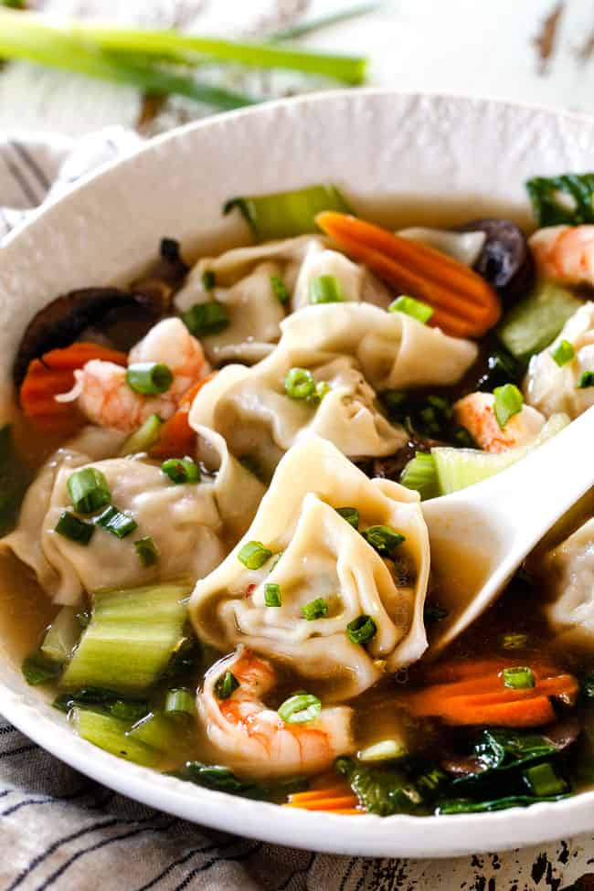spooning a wonton in easy wonton soup recipe