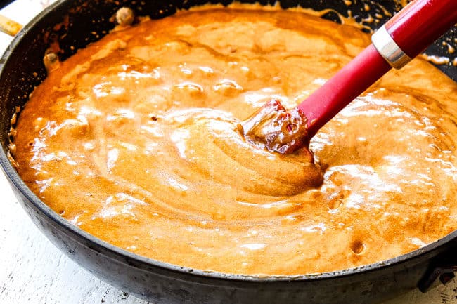 showing how to make caramel popcorn by stirring baking soda and vanilla into caramel sauce